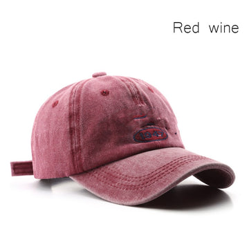 Rich burgundy vintage cap. A bold pop of color with a rugged, weathered aesthetic.