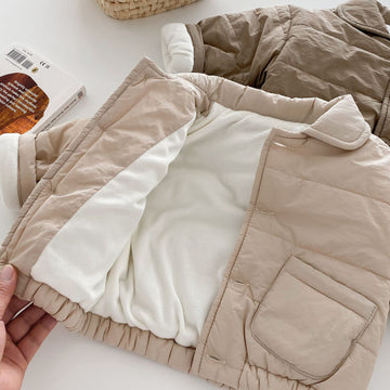 Neutral Sand: A versatile, gender-neutral jacket in a warm tan shade. Crafted from soft, windproof fabric with elasticated cuffs to keep the warmth in.