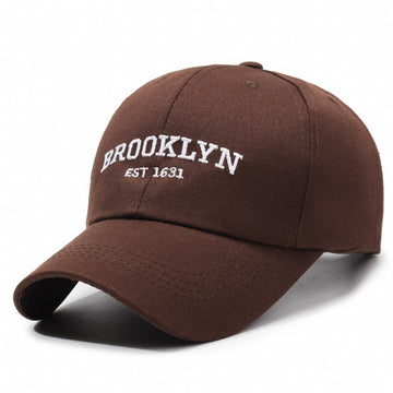 Rich coffee-toned twill. Features high-contrast white lettering for a warm, vintage aesthetic.